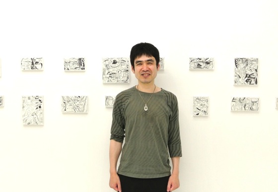 Yuichi Yokoyama in front of his works